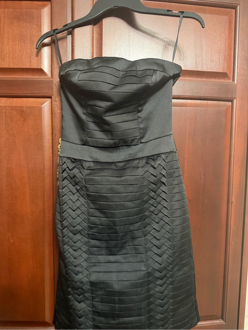 Black satin strapless mini dress with pleated details by H&M.